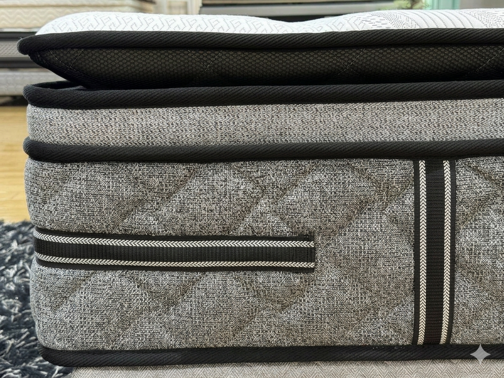 Gray mattress with black straps on a wooden floor